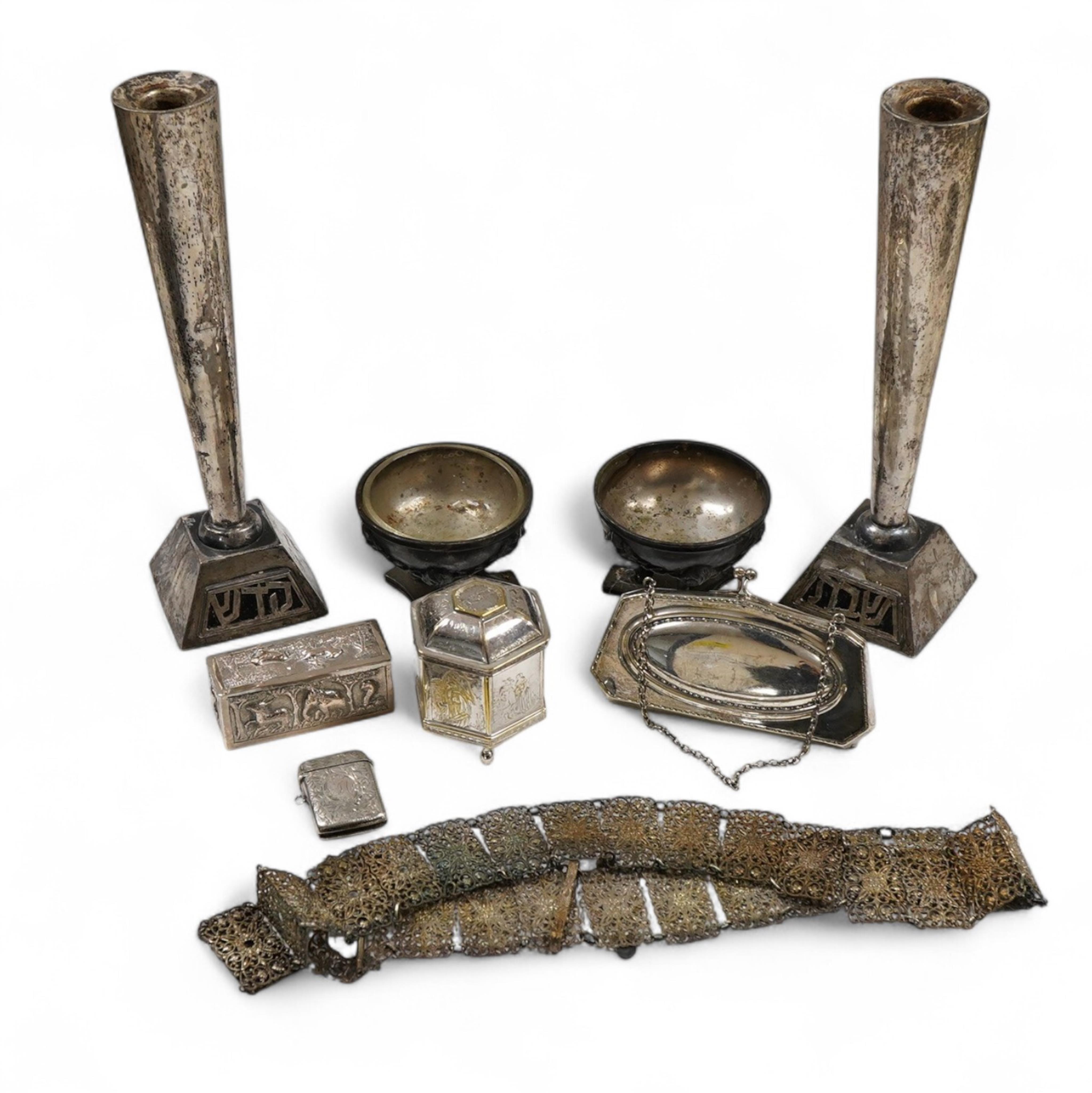 An Edwardian silver vesta case, Birmingham, 1902, 42mm, together with a small Indian white metal box, a pair of white metal Soviet? candlesticks, a plated purse, a plated belt, a hexagonal box and cover stamped MMA and a
